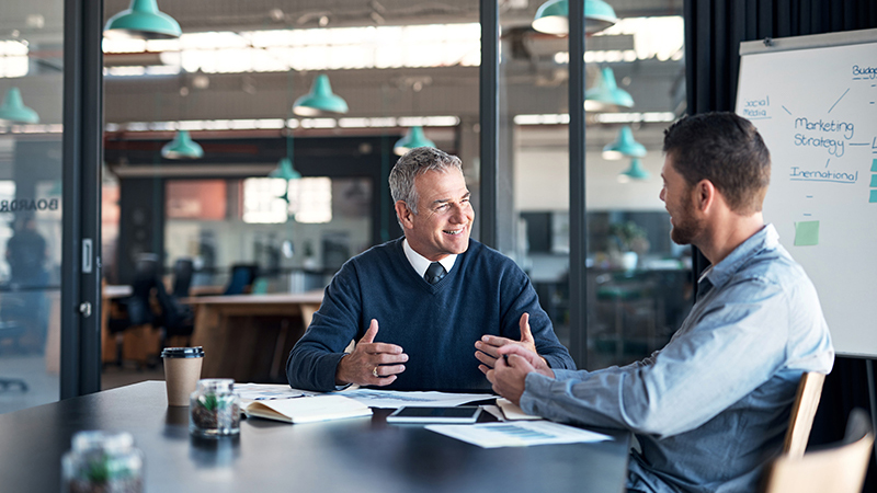 Two men talking at a restaurant
