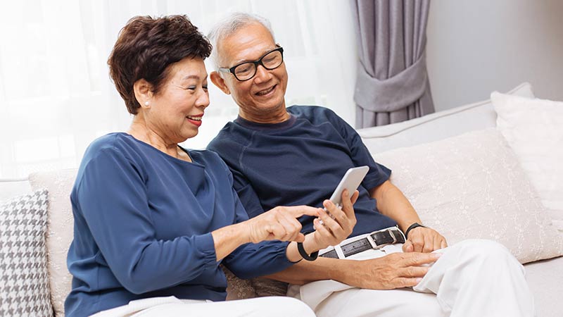 couple on the couch looking at their phone