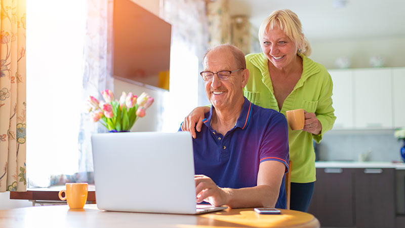 couple at desk looking at a computer
