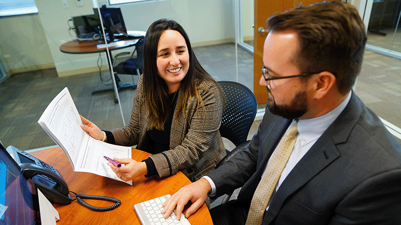 fisher employees analyzing documents in a conference room 