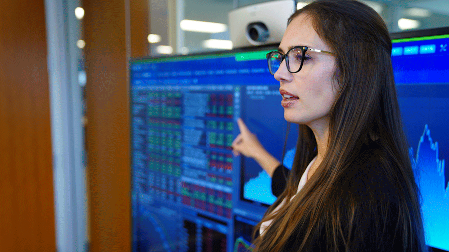 Woman pointing to monitors