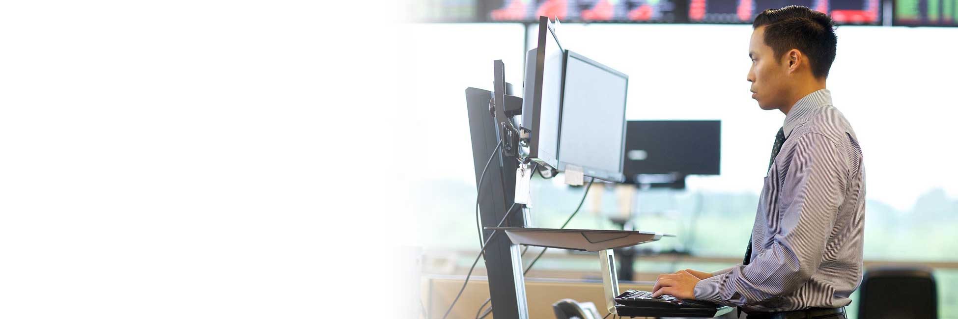 Man working on computer at standing desk
