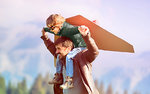 Dad plays plane with his son on his shoulders