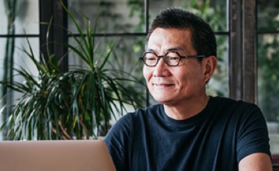 Man sitting in front of laptop smiling