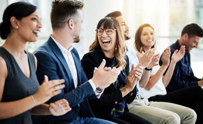 Financial Professionals Clapping During an Investment Philosophy Meeting