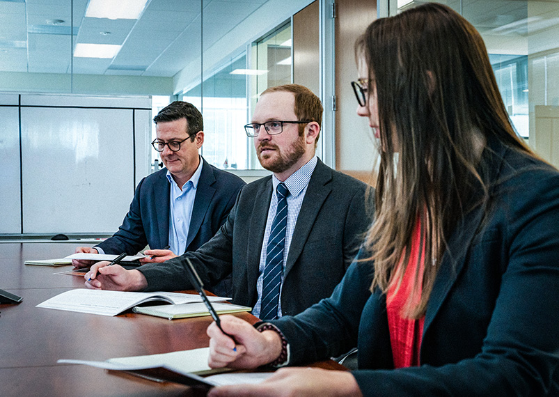 Group of business people sitting at a desk during a meeting