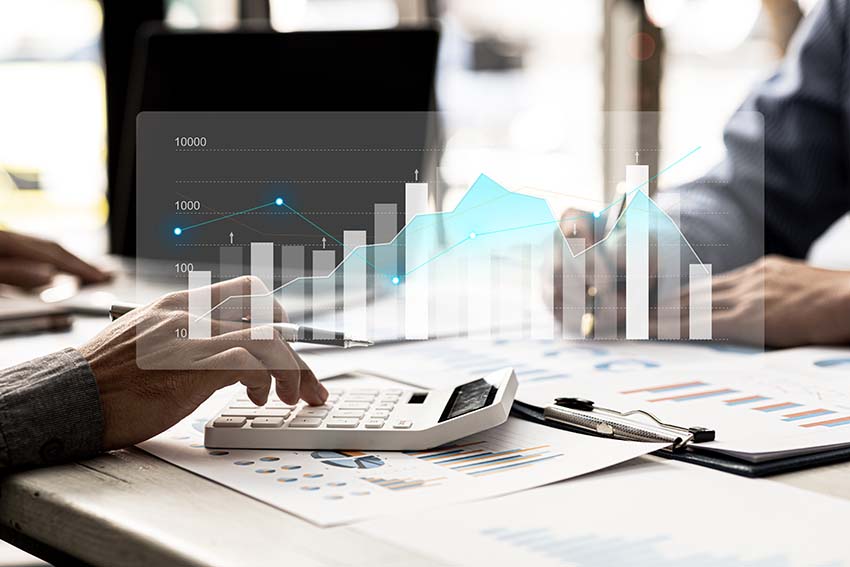 Person typing on a calculator with a graph overlay