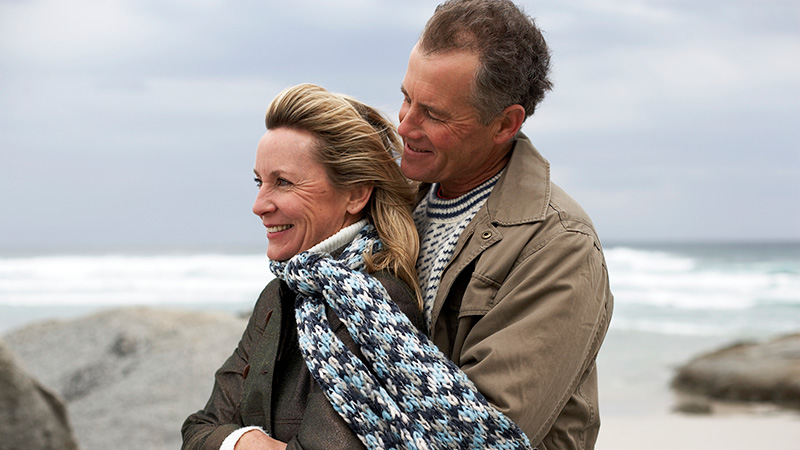 A couple hugging by the coast