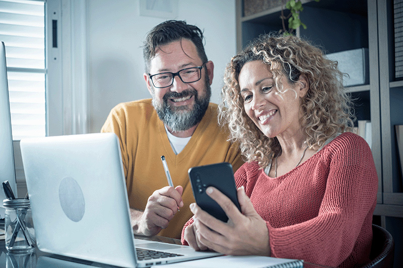 couple reviewing stocks, bonds, mutual funds and ETFs for their 401k and IRA retirement accounts