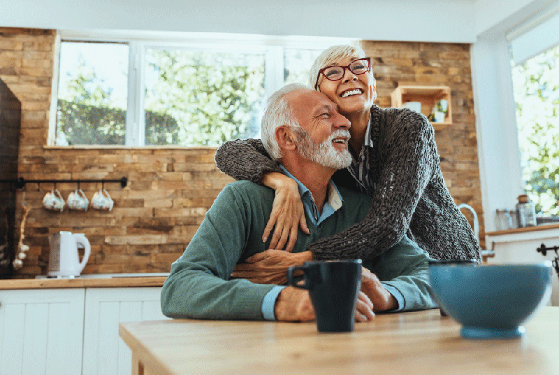 Couple smiling and hugging in a kitchen
