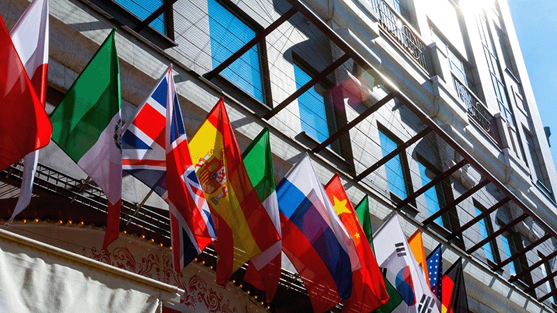 Flags from around the world haging from a building