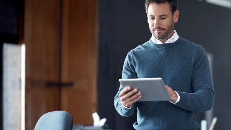 Standing person using a tablet