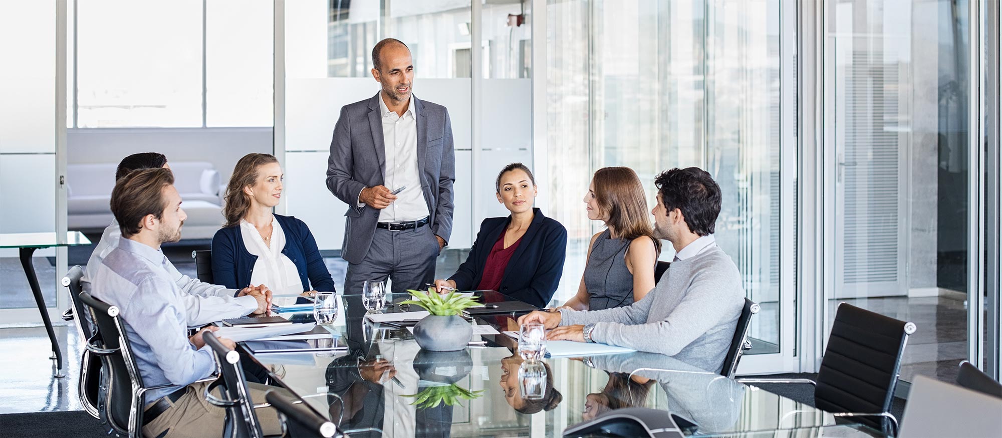 Person in a meeting about Fiduciary responsibility presenting to several others