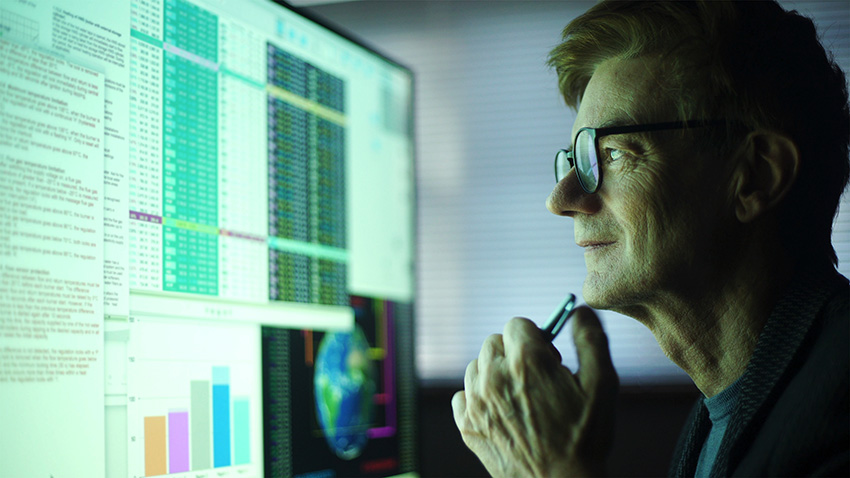 Person studying alternative investment charts on a monitor