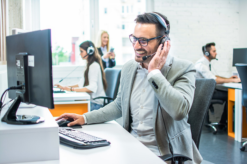 Person on the phone using a headset at a computer