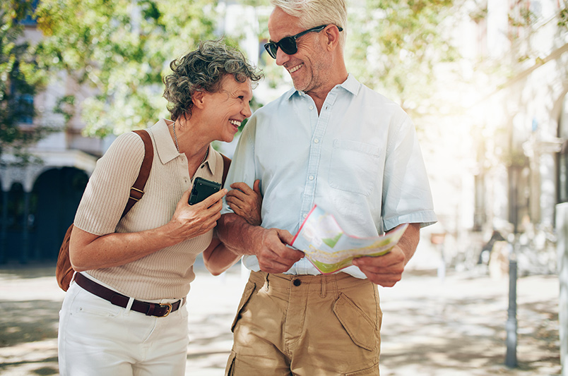 Couple walking outside along the street laughing