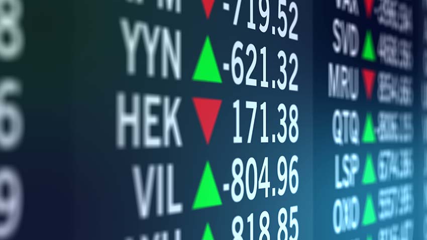 Image of a screen with stock market ticker symbols with a black background