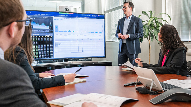 fisher employees analyzing documents in a conference room 