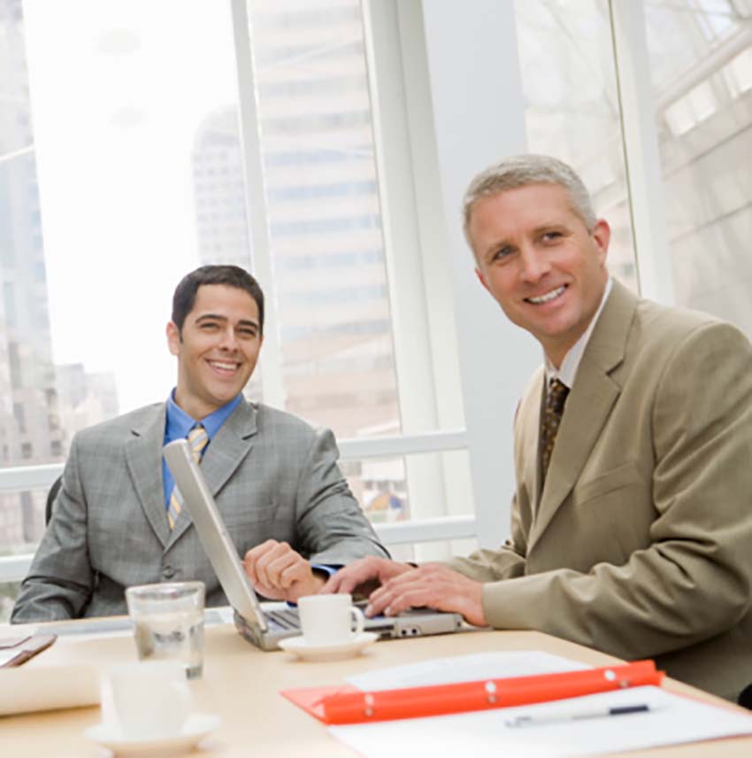 two business professionals smiling at the camera