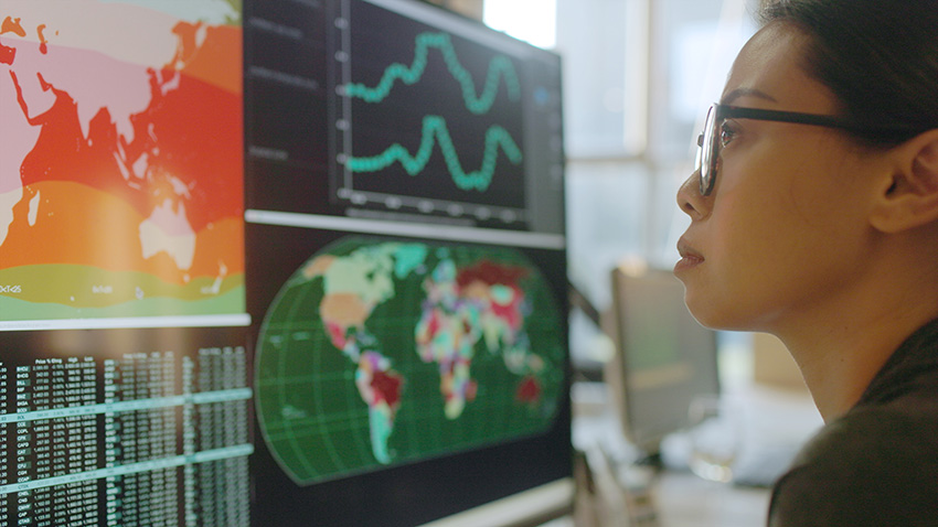 Person studying charts on a monitor to avoid common retirement investing mistakes