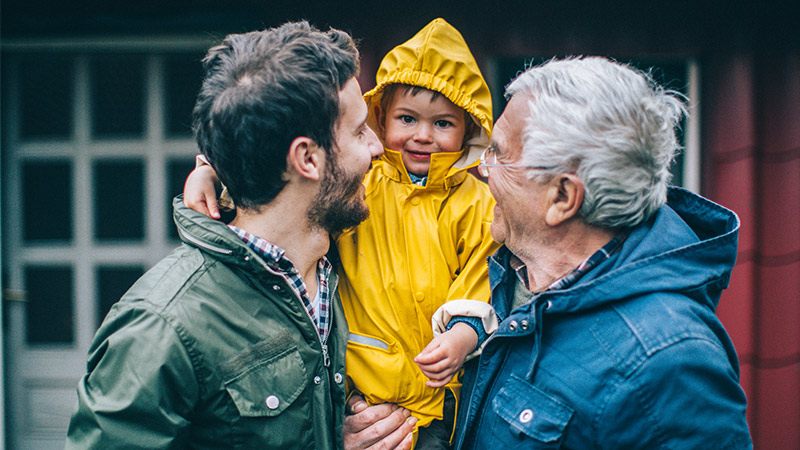 A photo of a child with his father and grandfather