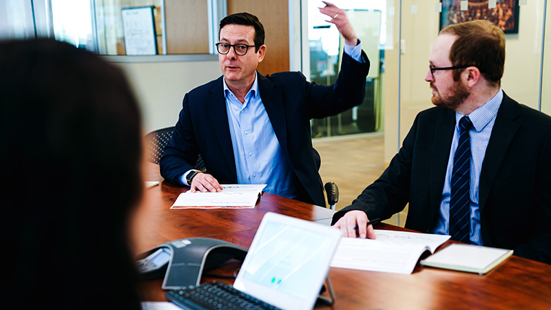 Business man talks in a meeting using his hands