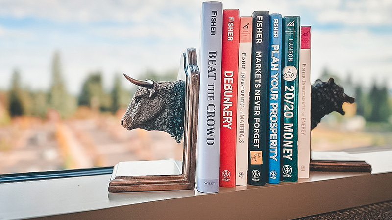 A Bull and Bear book ends hold some books about investing