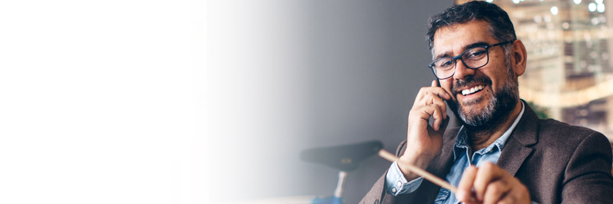 Man talking on phone in front of exercise equipment