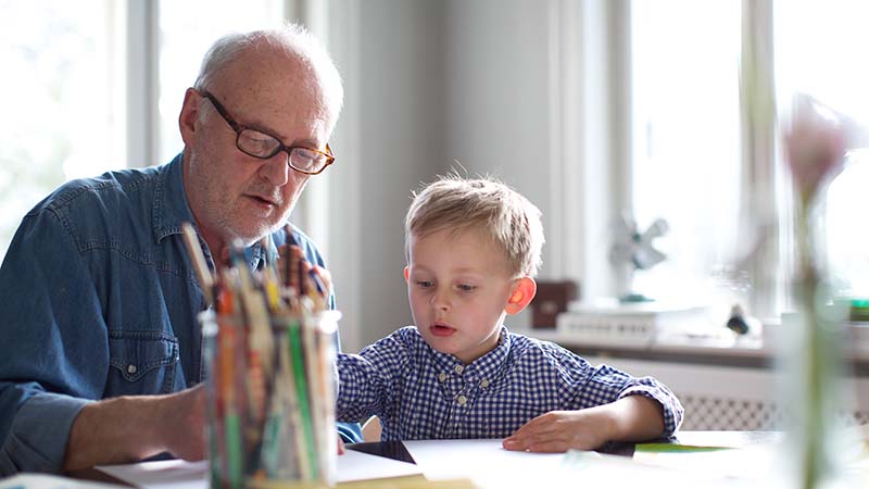 Grandpa draws a picture  with grandson